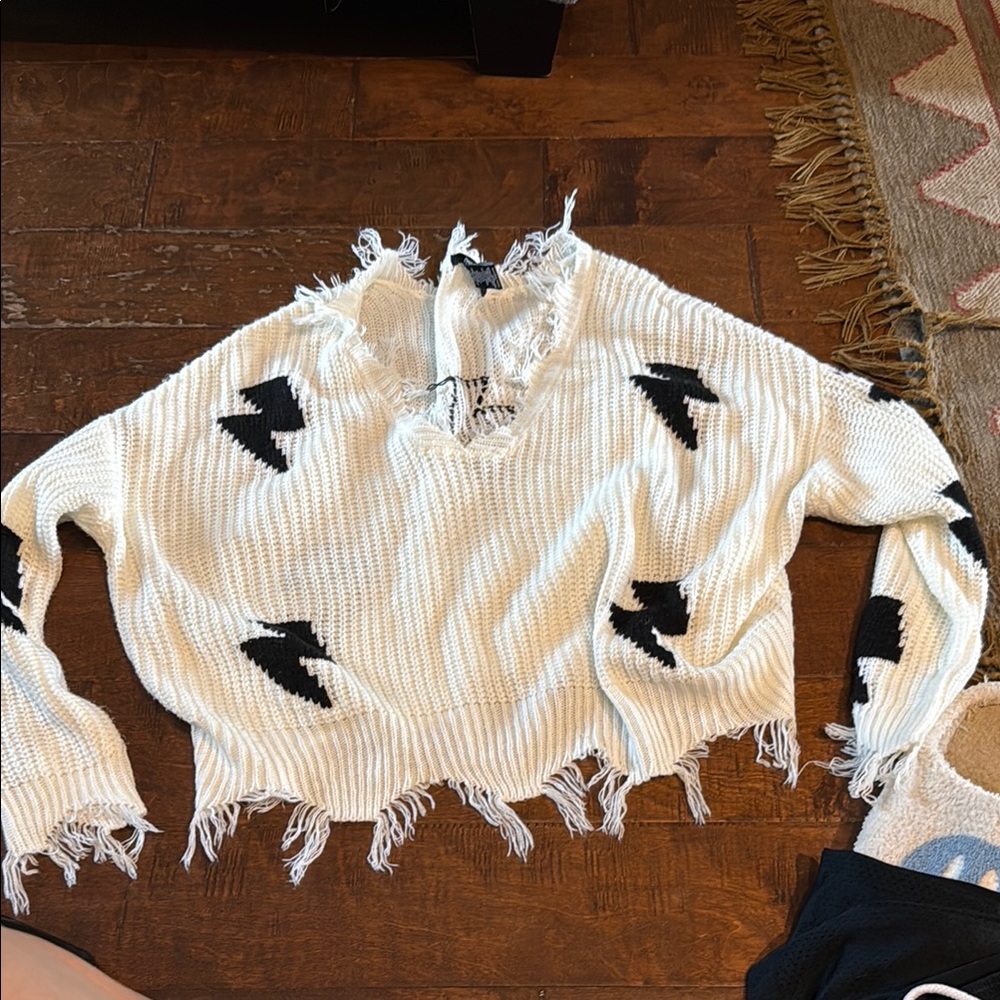 White and Black V-Neck Sweater with Distressed Design